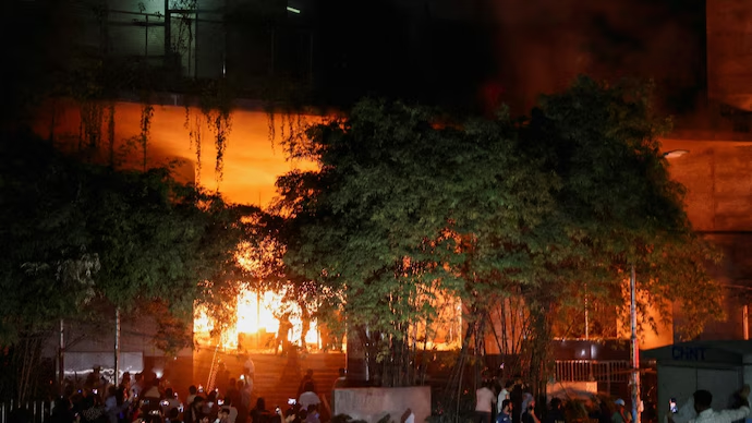 Building engulfed in flames at night in Bangladesh