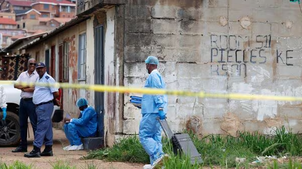 South Africa shooting: A police forensics member arrives at the scene where several people, including three minors, were killed in a mass shooting in Saulsville Hostel in Atteridgeville in Pretoria, South Africa, December 6, 2025. (REUTERS)

